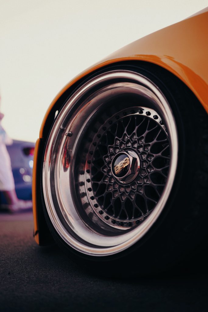 Nahaufnahme einer polierten BBS-Felge an einem extrem tiefergelegten, gelben Auto während der Stance Adria, Kroatiens Riesen Autotuning Treffen auf der Insel Krk.